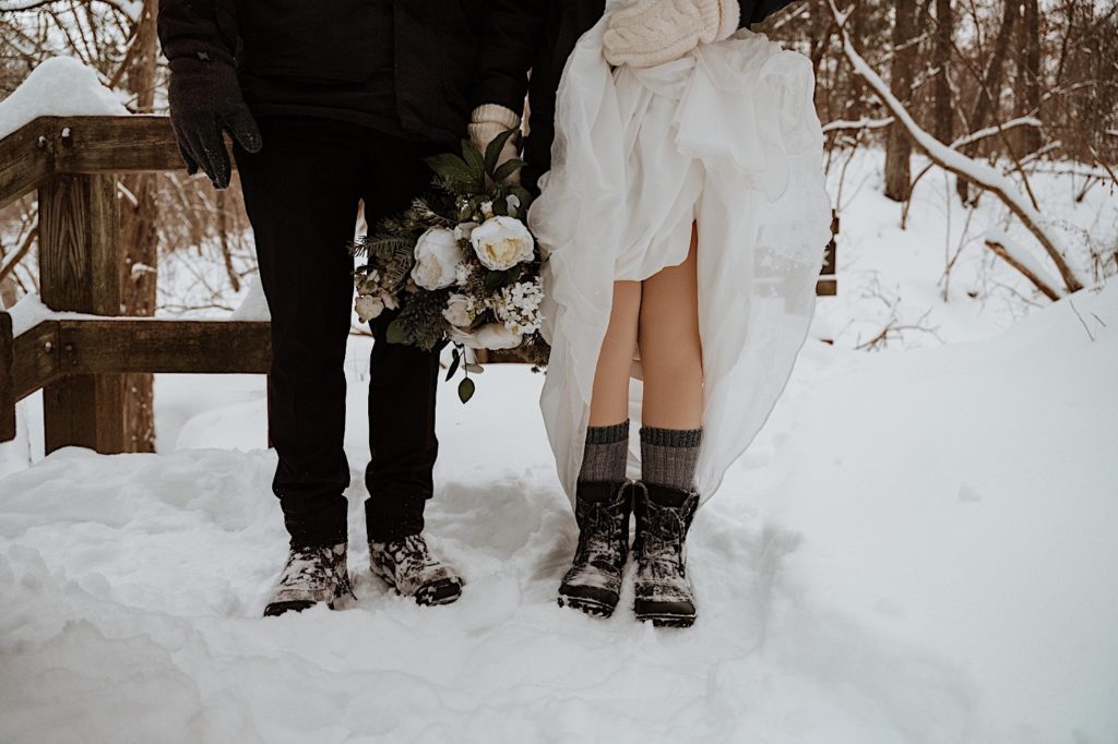 The bride and grooms snow boots under their wedding gear at Starved Rock National Park