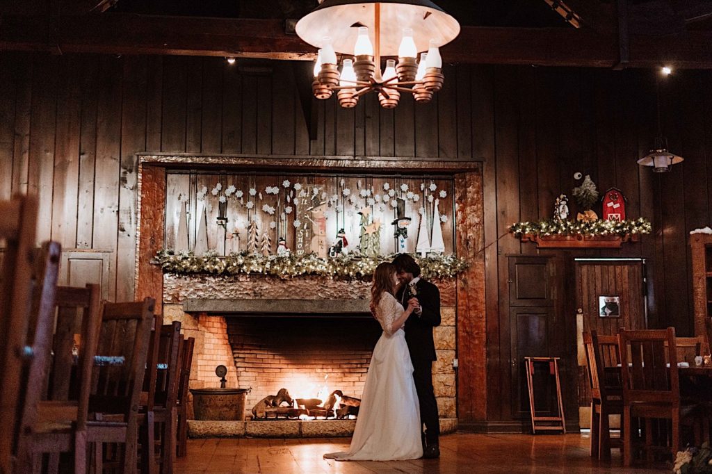 A bride and groom share a first dance in front of the fireplace after taking their wedding portraits at Starved Rock National Park.