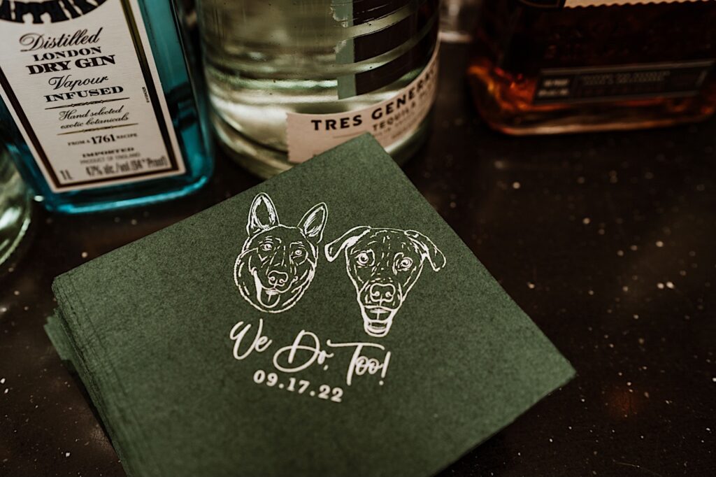 Wedding napkins with the bride and grooms wedding date on the napkin along with graphics of their dogs faces.  