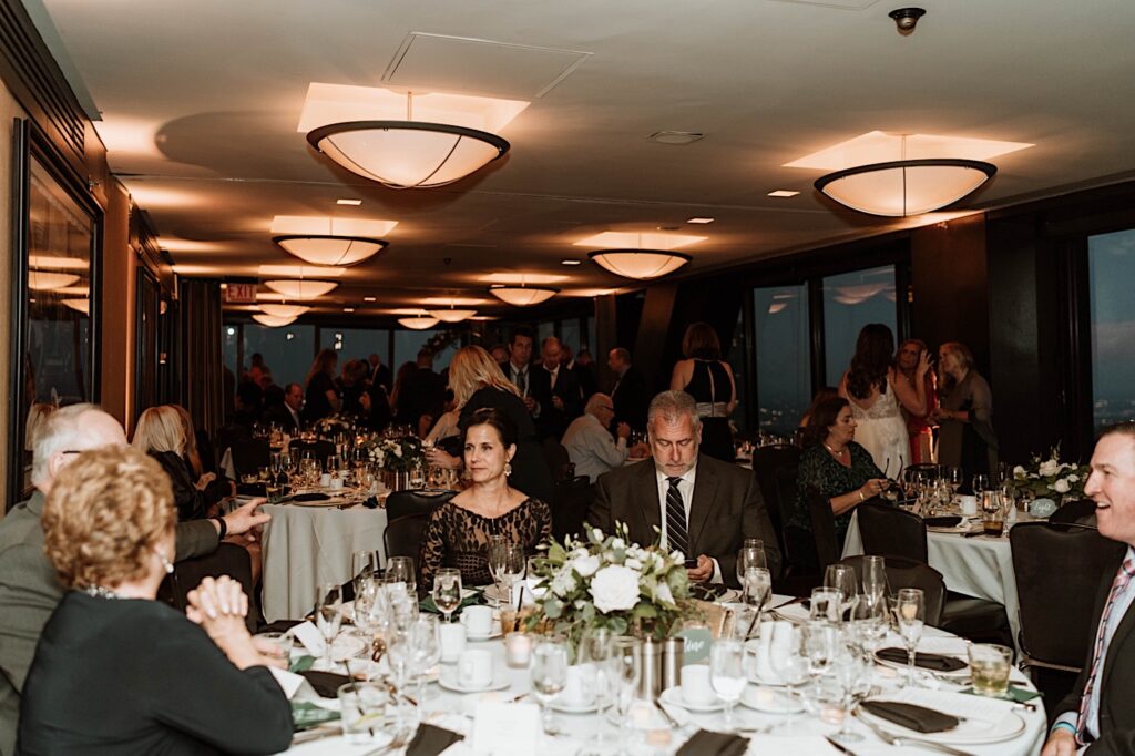 Guests enjoying dinner on the 95th Floor Signature Room at a wedding.