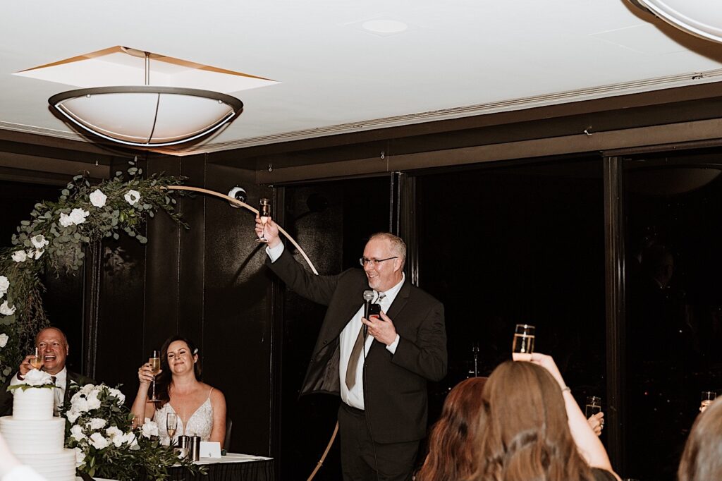The father of a bride toasts the newly weds during their wedding reception at their Chicago wedding venue.