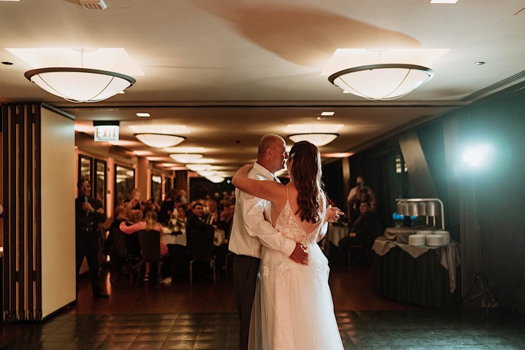 A bride and groom have their first dance at the Signature Room on the 95th floor.