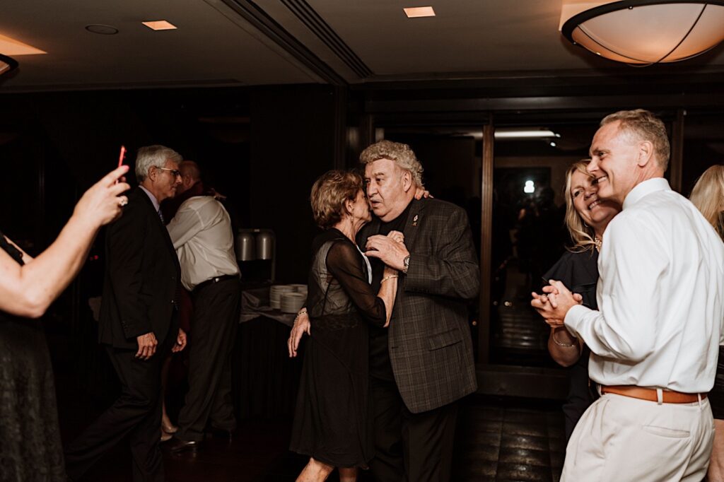 guests dance during a wedding reception thrown on the 95th floor of the John Hancock Building