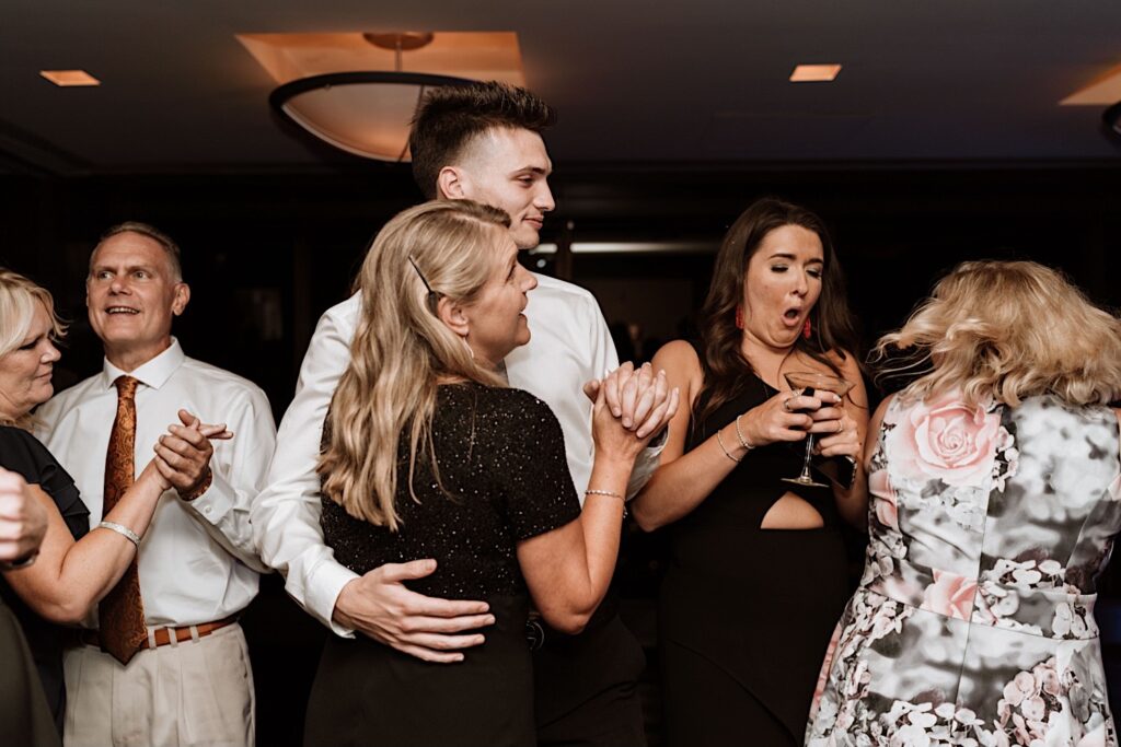 guests dance during a wedding reception thrown on the 95th floor of the John Hancock Building