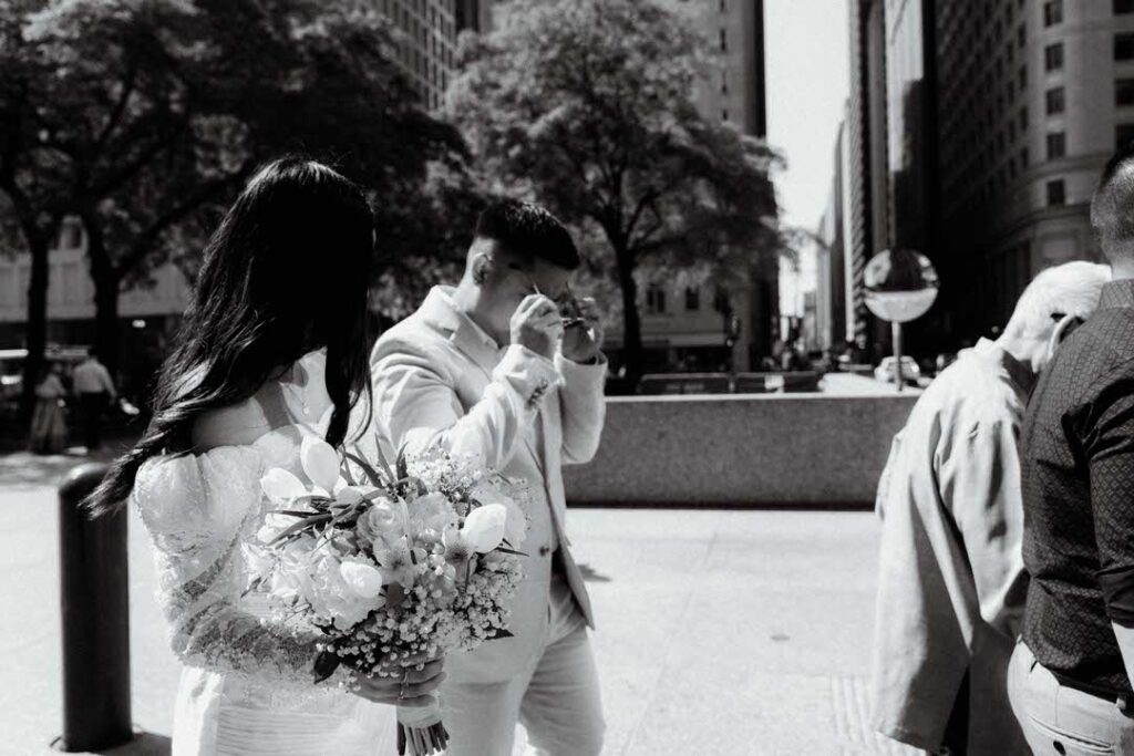 bride and groom walking on an crosswalk