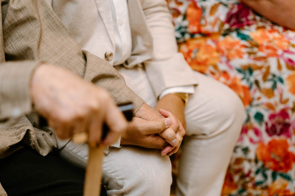 close up hands: two people holding hands