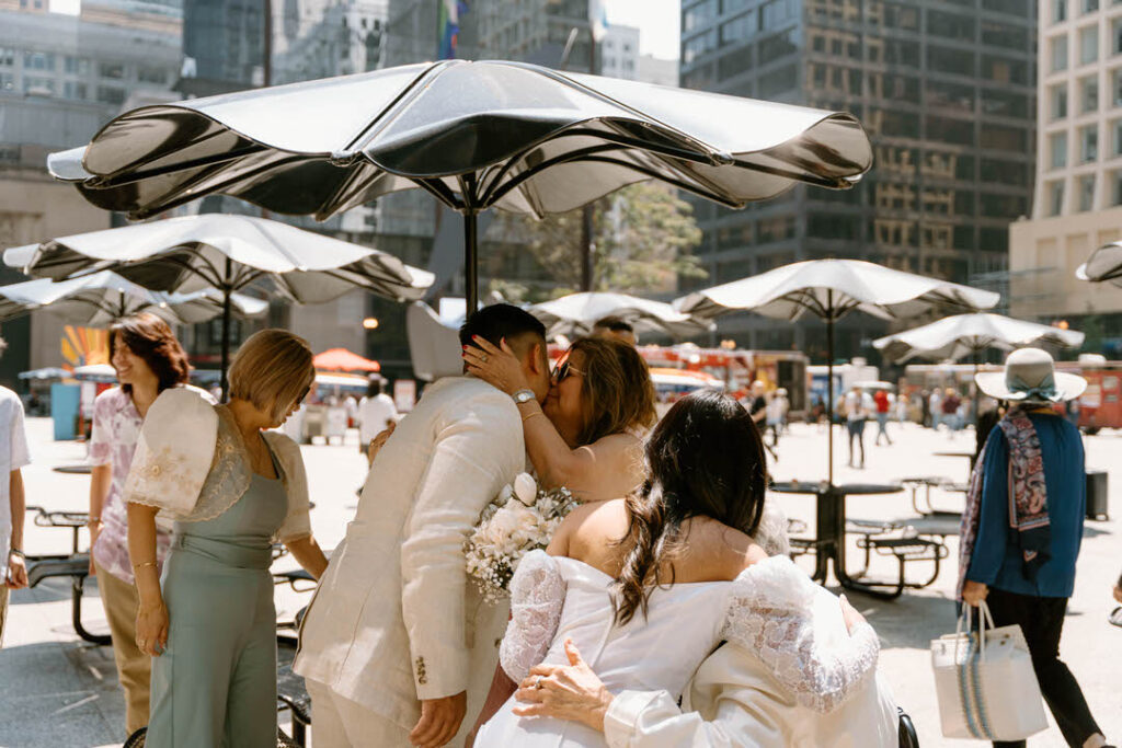 groom's mom hugging and kissing groom's face -chicago city hall elopement