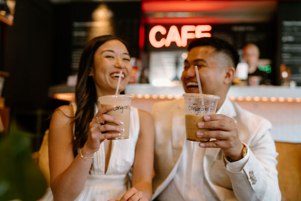 two people laughing with a cup of coffee in their hands - chicago city hall elopement