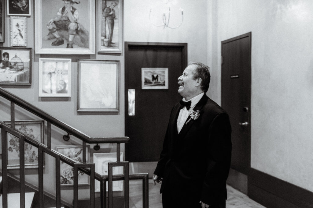 a man looking up the stairs in awe