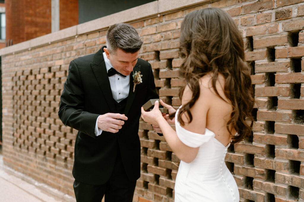 groom looking at the gift his bride got him