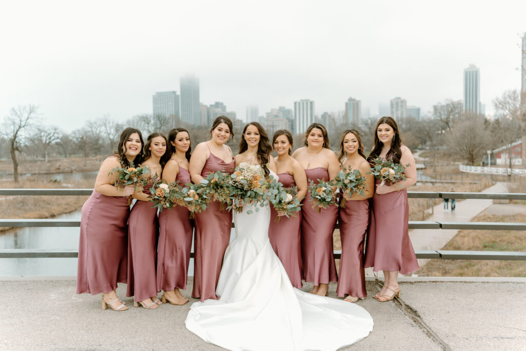 bride and her bridesmaids posing for the camera