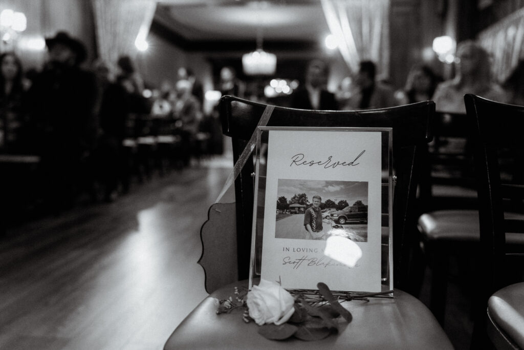 black and white photo of a reserved seat for the groom's late father