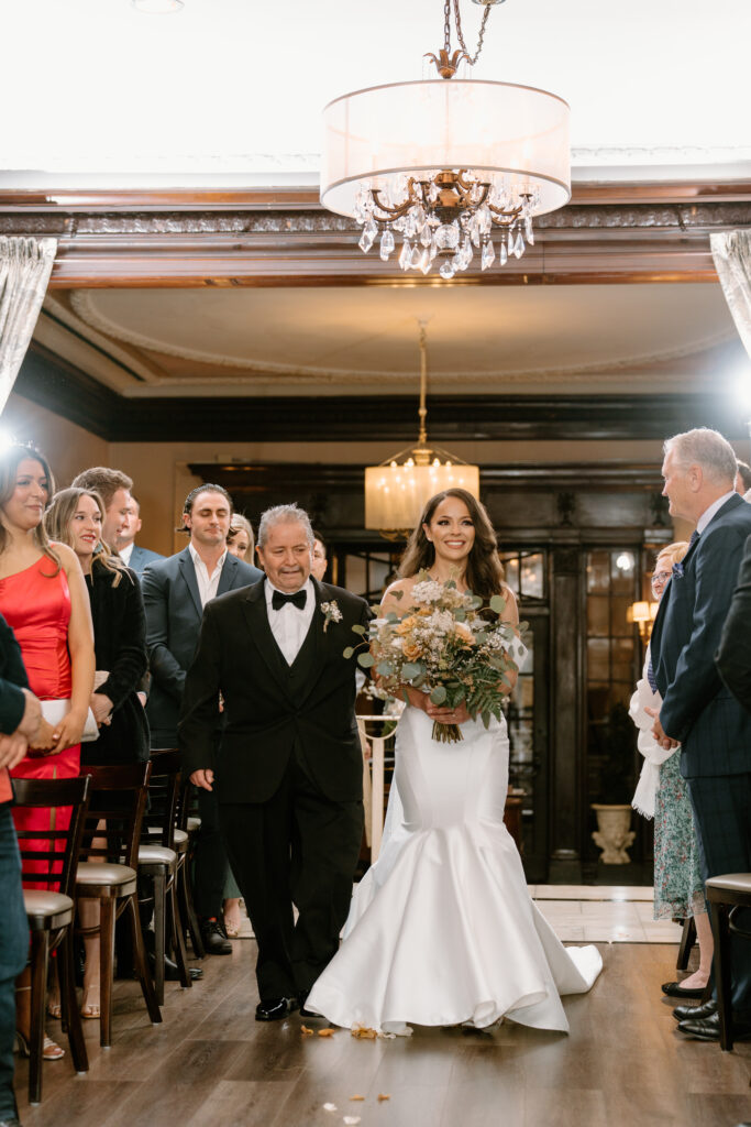 bride walking down the aisle with her dad