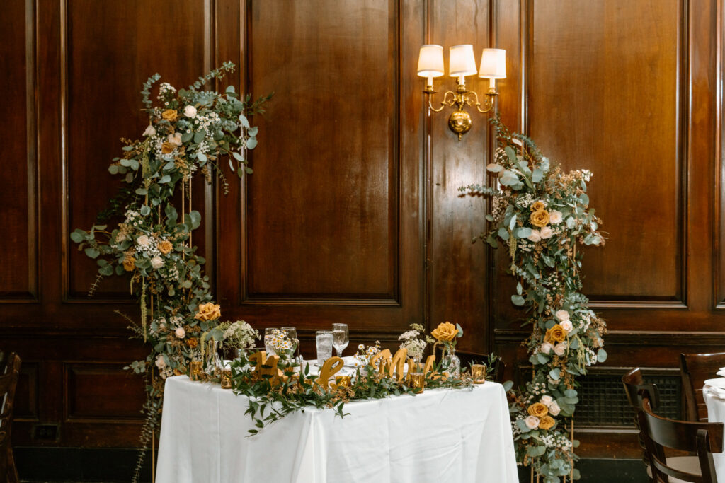 sweetheart table with a curved floral arch